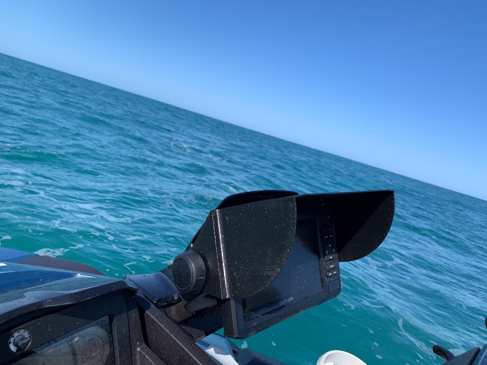 Black JetSkiVisor fitted on a Garmin fish finder, ocean background